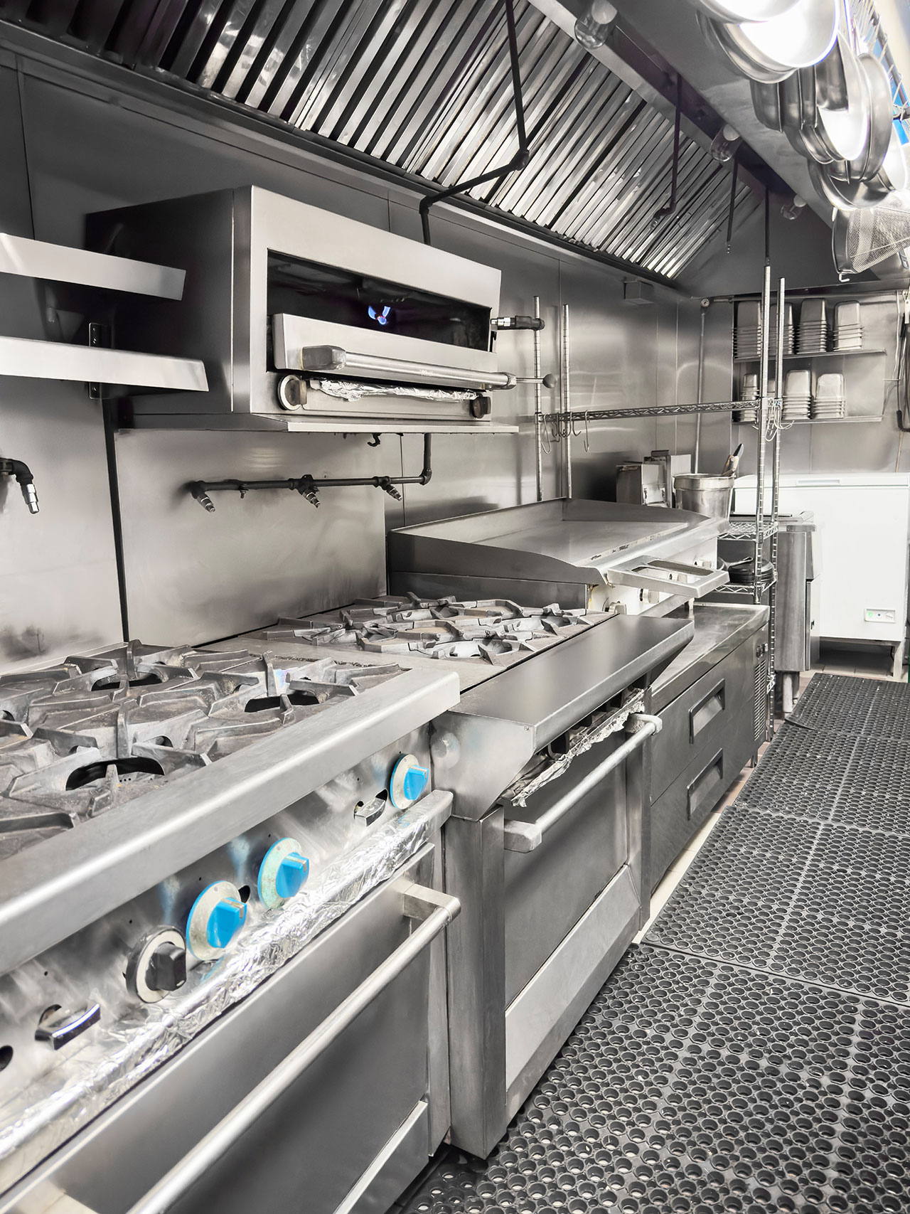 Fitted commercial kitchen line ahead of a strip out