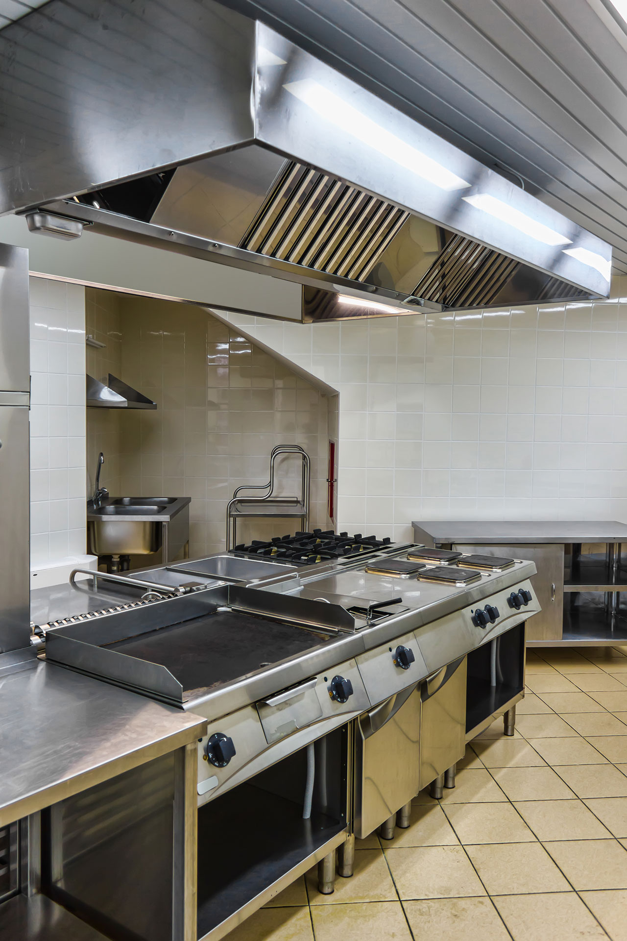 Commercial cooking suite and extraction canopy awaiting disconnection