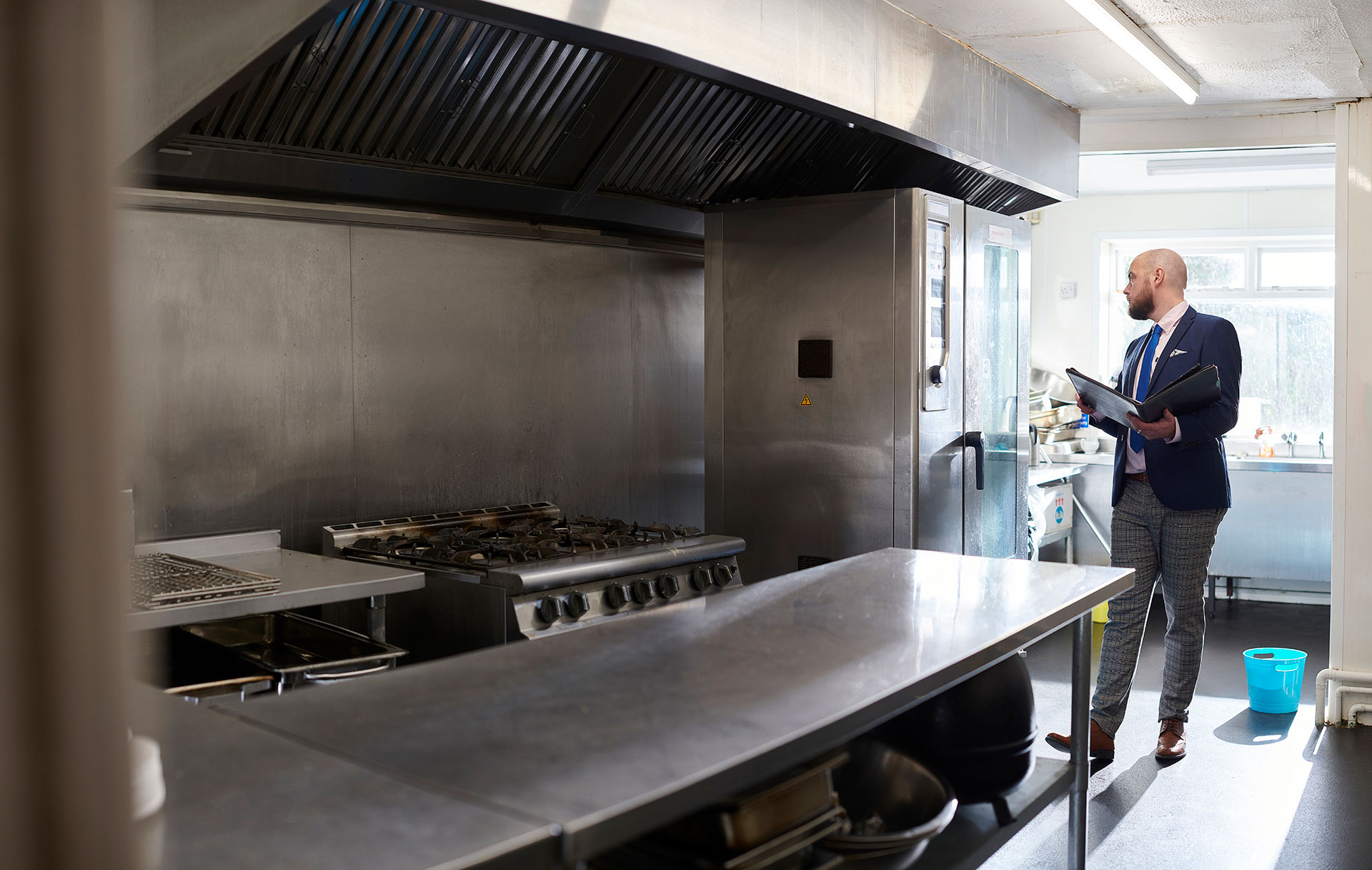 Surveyor assessing a commercial kitchen ahead of a strip out